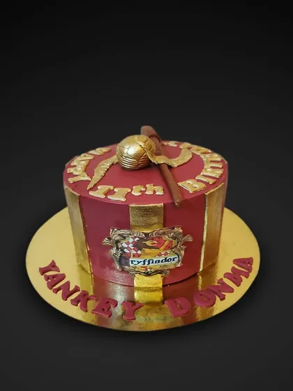 For the Harry Potter fans! This Gryffindor-themed cake is decorated in house colors and topped with a golden snitch and broomstick, all made from fondant.