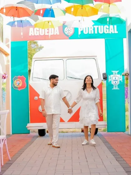 A fun, dynamic shot of the couple walking through a colorful, Portugal-themed alleyway. This set offers a unique and vibrant background for a pre-wedding shoot that feels like a European holiday.