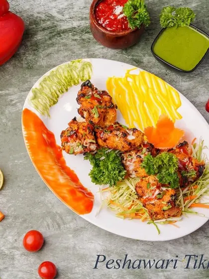 Hailing from the frontier, Peshawari Tikka is known for its milder spice profile. The chicken is marinated in a simple yet flavorful mix, allowing the natural taste of the grilled meat to shine through.