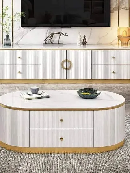 A luxurious TV cabinet and center table set, finished in white with fluted details and a golden metal base for a coordinated and opulent look.