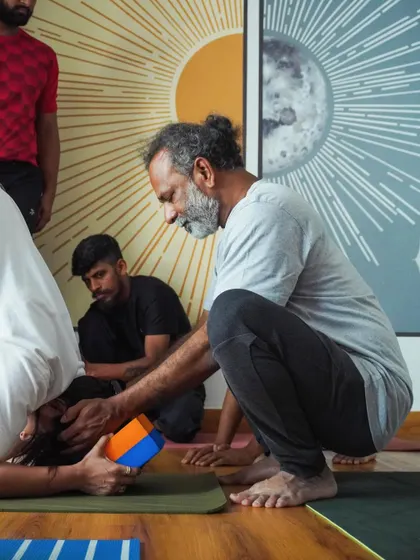 Yoga is a journey within. Here, Srinatha Sir provides a hands-on adjustment to a student in an inversion, ensuring safe alignment and deeper expression of the pose.