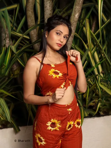 This outdoor shot captures a candid moment, adjusting the outfit. It adds a touch of authenticity to the lifestyle session.