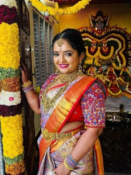 A happy smile from a bride on her special day. I love how the intricate, multi-colored threadwork on her blouse sleeves stands out against her beautiful silk saree.