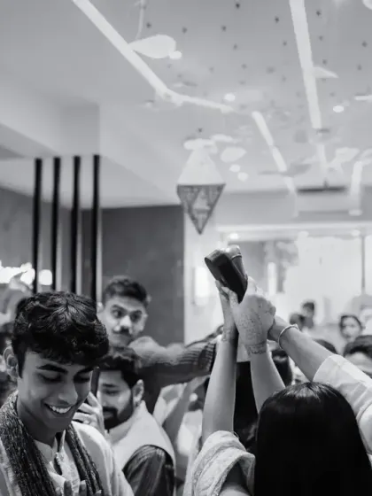 A fun, candid black and white shot of the groom's welcome during his intimate home wedding.