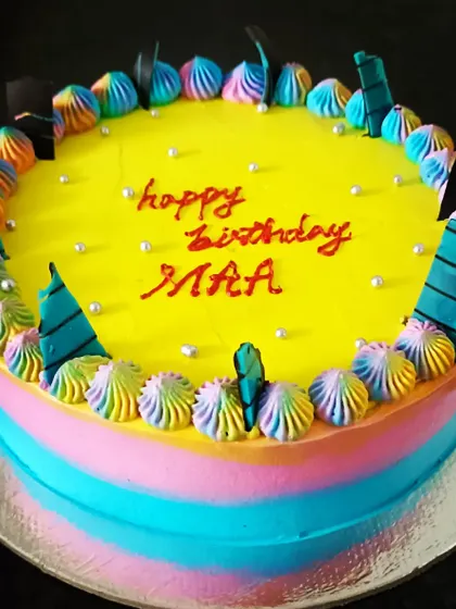 A vibrant 'death by chocolate' cake with colourful rainbow piping for a fun and delicious celebration.
