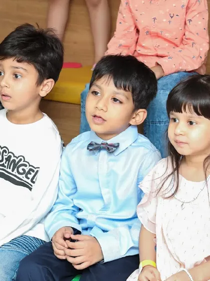 Young guests sitting together, completely engaged by the party activities.