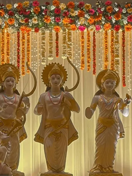 This image shows the full context of our traditional floral backdrop, created for a religious event featuring idols of Ram, Sita, Lakshman, and Hanuman. We design decor that is respectful and appropriate for the occasion.