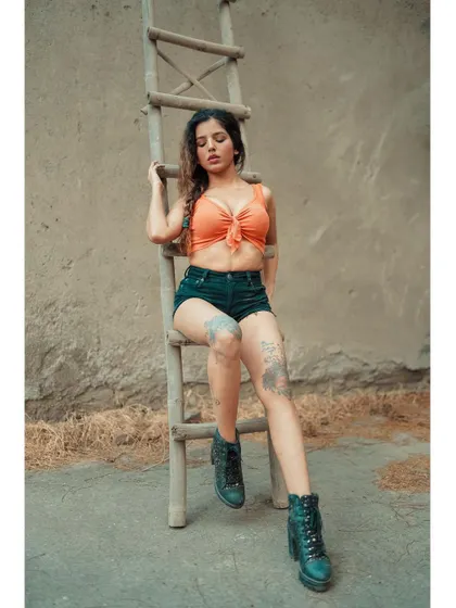 A different angle from the ladder shoot, focusing on a more pensive expression. The textures of the wall and ladder add a lot of character to the shot.