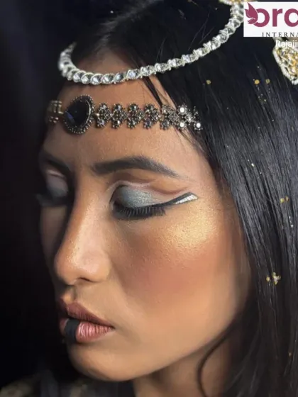 A side view of the Cleopatra look, highlighting the sharp lines of the eyeliner and the intricate headpiece.