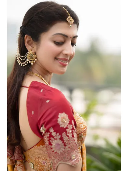 A beautiful profile shot highlighting the traditional hairstyle and earrings. The soft focus on the background keeps the attention on the subject.