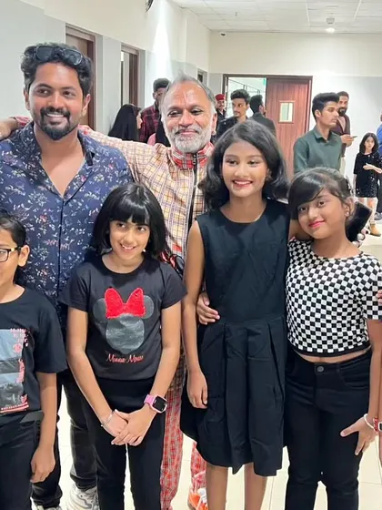 A proud moment with my students and a professional model after a successful fashion show. These experiences are invaluable for their growth.