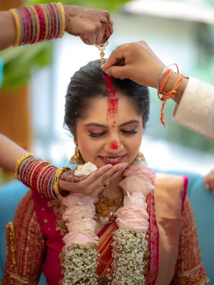The application of the sindoor is a powerful and significant ritual. I focused closely on the hands and the bride's serene expression to capture the importance of this moment.