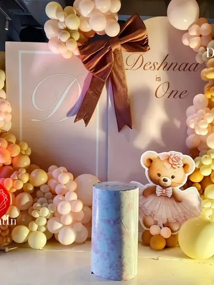 Bows, bears, and beautiful balloons make for the sweetest first birthday. This setup for Deshnaa's party uses a soft, warm color palette and a giant velvet bow to create a chic and adorable focal point.