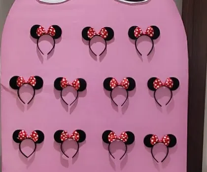 A close-up of the Minnie Mouse ear headbands, ready for guests to pick up and wear during the party.