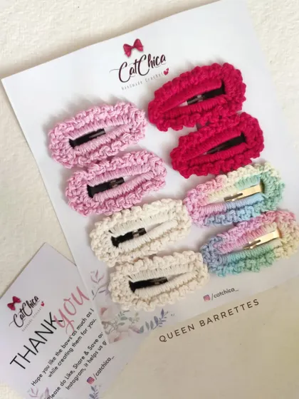 A "Queen Barrettes" set with eight clips in shades of pink and cream, plus a rainbow clip.