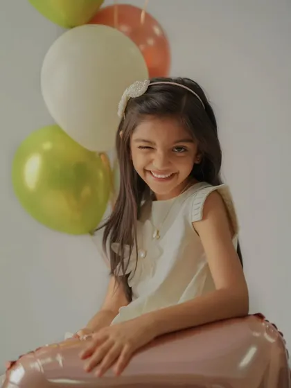 A playful wink from the birthday girl. My sessions are all about having fun, which helps me capture genuine expressions and candid moments like this.