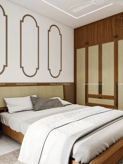 This bedroom features a beautiful blend of wood and fabric textures. The decorative wall mouldings and jute-paneled wardrobe doors add a touch of rustic, traditional charm.