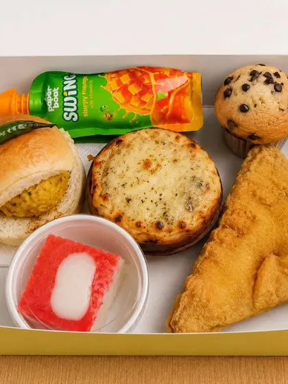 Vada pav, bread pakoda, a muffin, honey cake and a mango drink fill this sample snack box we put together.