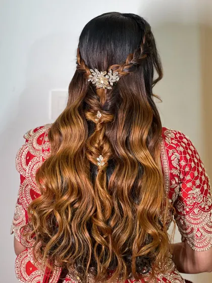 A beautiful half-up style with a combination of braids and waves. The crystal accessories add a touch of sparkle to this intricate look.