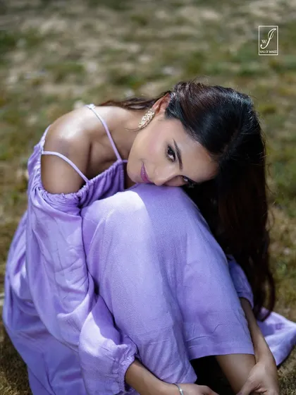 An intimate, gentle pose that draws the viewer in, focusing on the model's expression and the delicate straps of the dress.