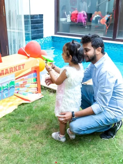 Another shot of the water gun game, capturing a fun family moment.