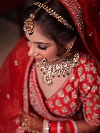 A beautiful top-down shot of the bride, highlighting her maang tikka and necklace.