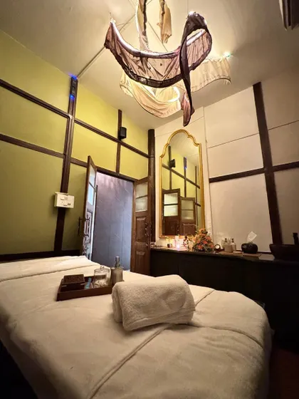 The unique decor of our Guwahati spa room, featuring traditional Assamese design elements. The warm lighting and rich wood accents create a cozy and culturally rich environment for your massage.