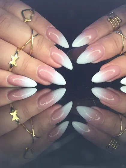 A full view of the dramatic stiletto baby boomer manicure, showcasing the perfect gradient.