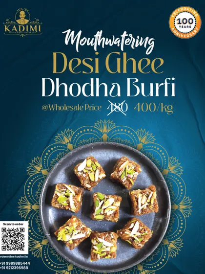 A plate of our mouthwatering Desi Ghee Dhodha Burfi, garnished with nuts. This traditional sweet is a perfect treat for any celebration.
