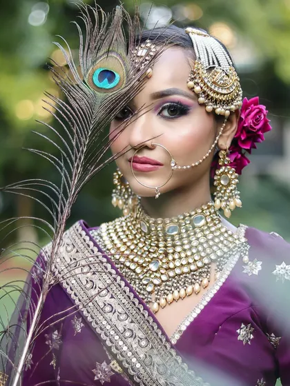 This creative shot with a peacock feather adds an element of drama and symbolism to the bridal portrait.
