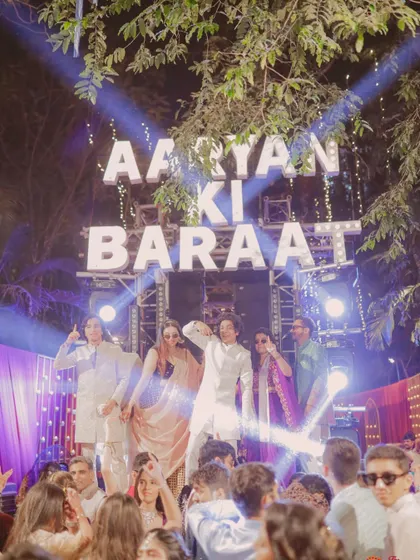 The whole squad dancing under the "AARYAN KI BARAAT" sign. I make sure the baraat is a personalized and high-energy affair.