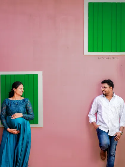 This creatively composed shot shows the couple looking at each other across the frame. It's a modern and artistic way to represent the connection and anticipation of expecting parents.