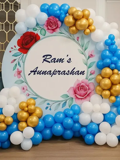 A simple and sweet backdrop for an Annaprashan ceremony. I use a custom-printed circular board with the baby's name, framed by a blue, white, and gold balloon arrangement.