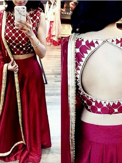 This two-piece lehenga features a stylish backless crop top with a full skirt. I can tailor both pieces to ensure a perfect fit, combining modern design with traditional elegance.