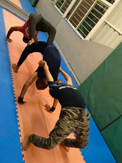 A different angle of our students performing a synchronized backbend train. This requires each person to trust the one behind them.