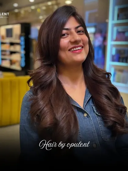 Hair game upgraded. This client's long hair was given new life with a fresh cut, adding layers for volume and shape, resulting in a gorgeous, flowing style.