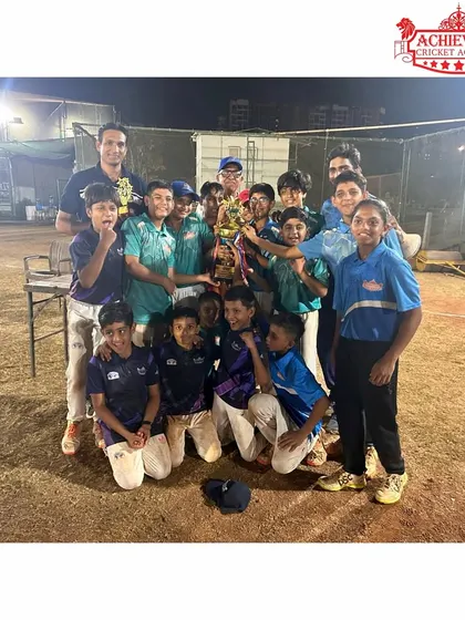 The U-11 team and coaches celebrating their night tournament victory together.