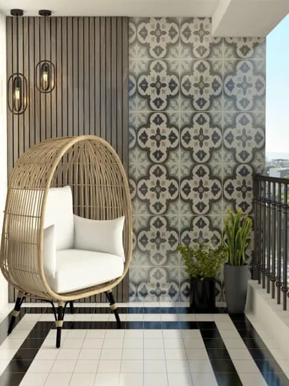 This modern balcony design combines a stylish rattan egg chair with bold patterned tiles. The black and white flooring creates a strong graphic statement, making the space feel both contemporary and comfortable.