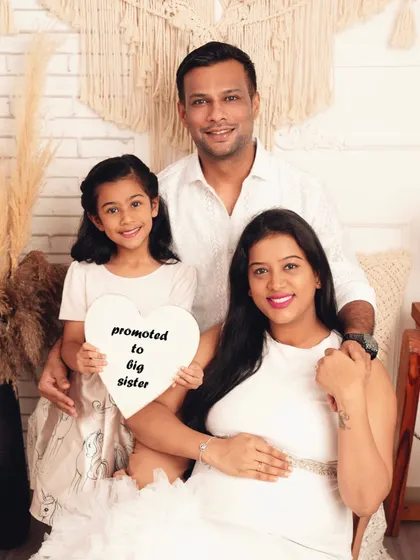 Promoted to big sister! I love capturing the moment when the whole family shares in the joy. This beautiful studio portrait shows a family eagerly awaiting their newest member.