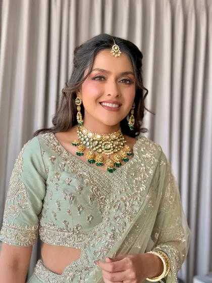 A soft glam look in a beautiful pastel green lehenga, perfect for a daytime event or mehendi.
