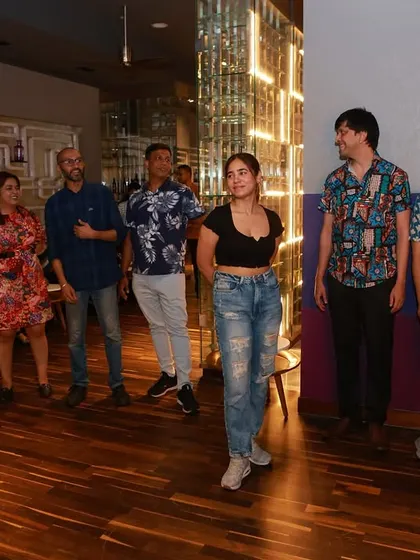 A group of people watching and waiting for their turn to dance, showing the social and supportive nature of our community.