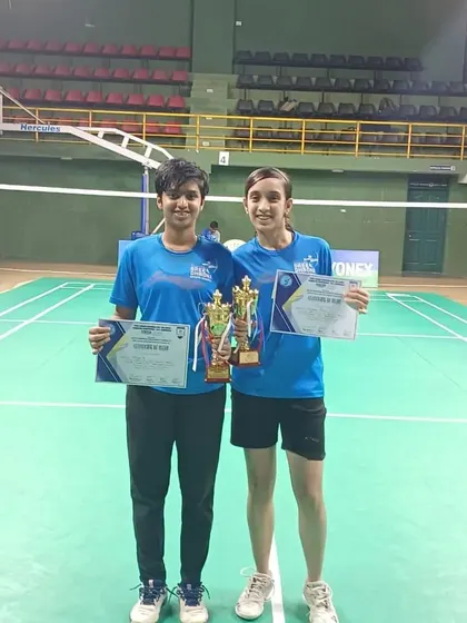 A duplicate image of our U17 girls doubles team with their trophies.