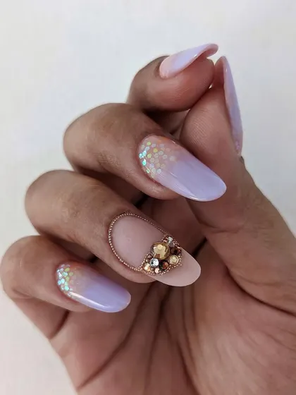 This angle shows the beautiful almond shape of the nail extensions, which complements the delicate crystal and ombre design perfectly.
