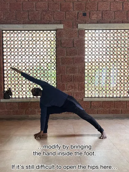 A simple modification for Parsvakonasana is to bring the hand inside the foot. This allows you to focus on opening the hips without straining to reach the floor.