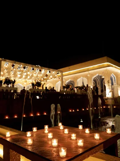 A table set with candles overlooking the fountains, offering guests a beautiful view of the entire celebration.