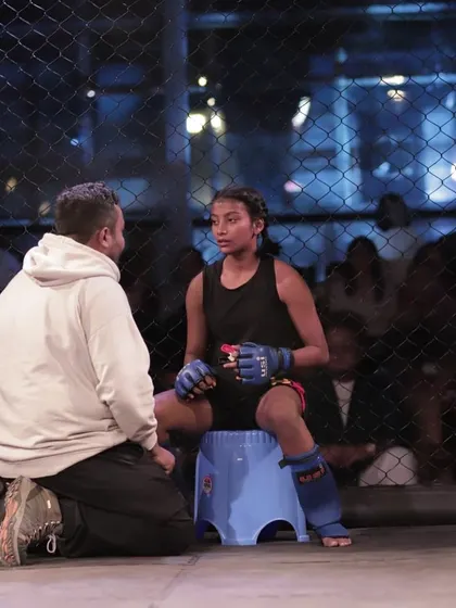 Cornering Vio Lina during a tough fight at Darjeeling Cage Warriors. My job is to be the calm in the storm, providing clear strategy and motivation between rounds.