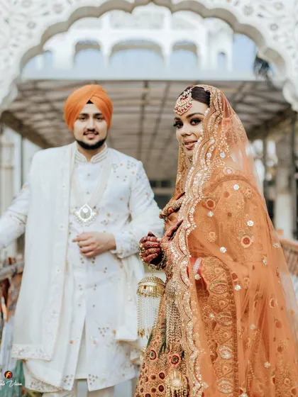 A beautiful shot focusing on the bride, with the groom slightly behind her, capturing her confident and radiant look.