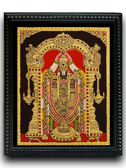 The framed 10x8 inch Balaji Tanjore painting, a miniature masterpiece. The traditional black frame enhances the artwork's golden glow, making it a perfect addition to any pooja room or desk.