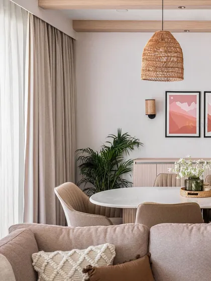 This image captures the calm and inviting atmosphere of the open-plan living and dining space. The consistent use of neutral tones, wood, and natural textures creates a harmonious flow.