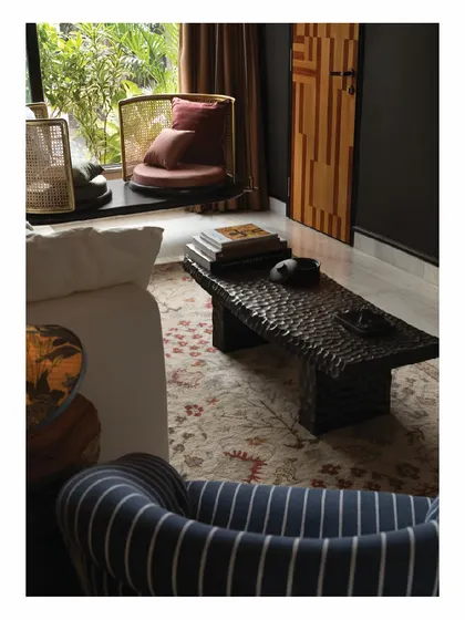 Another view of our personal lounge, showing the custom rotatable swing and a hand-carved coffee table. We believe in creating furniture that is not just for sitting, but for interacting with, making the home a place of comfort and discovery.